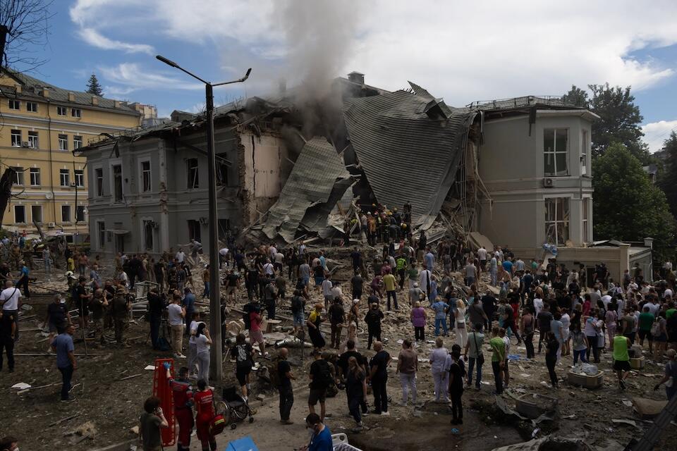 On July 8, 2024 in Kyiv, rescuers, hospital staff and volunteers clear rubble and search for people trapped under debris after an attack that hit Okhmatdyt Hospital, Ukraine's largest children's medical center.