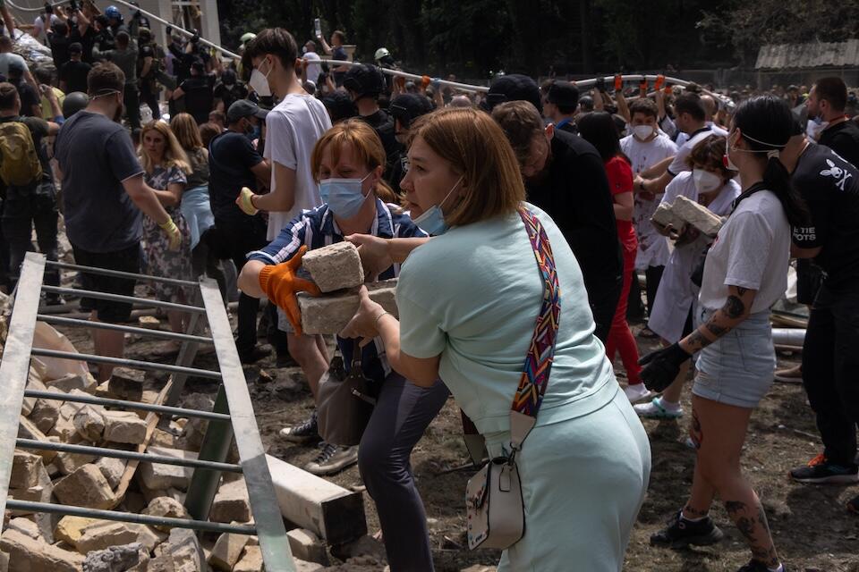 On July 8, 2024 in Kyiv, rescuers, hospital staff and volunteers clear rubble and search for people trapped under debris after an attack that hit Okhmatdyt Hospital, Ukraine's largest children's medical center.