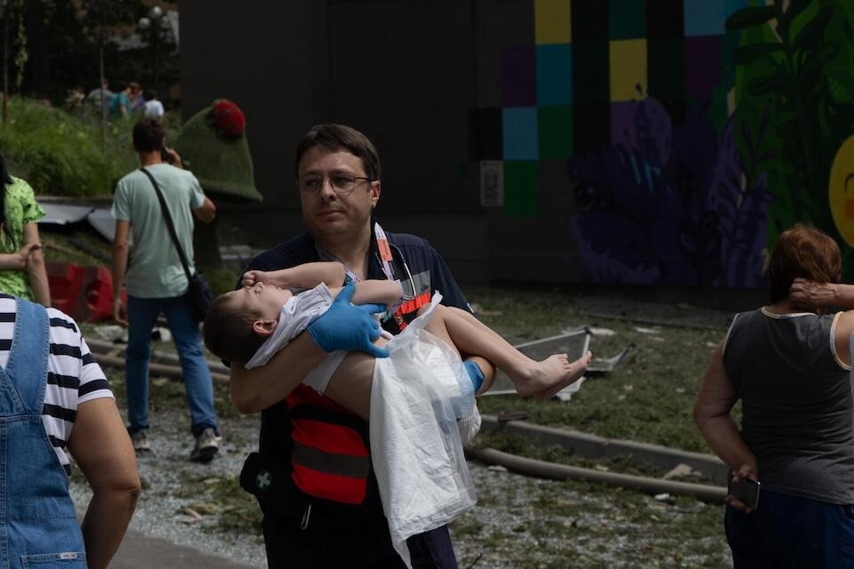 On July 8, 2024 in Kyiv, a resource worker carried a child as first responders, hospital staff and volunteers clear the rubble and search for people trapped under debris after an attack that hit Okhmatdyt Hospital, Ukraine's largest children's medical center.