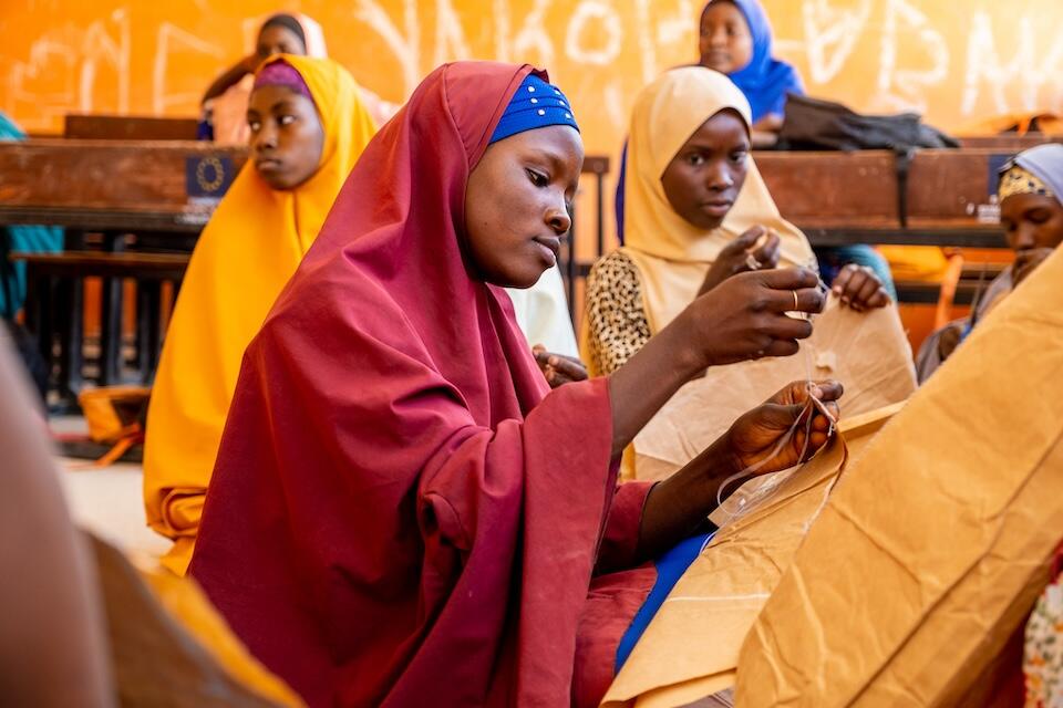 Adolescent girls learn to sew at a UNICEF-supported vocational training center in Gonidamgari Primary School, Maiduguri, Nigeria.