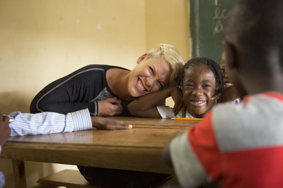 P!nk, UNICEF Ambassador since 2015, shares a special moment with a child at a UNICEF-supported school in Haiti.