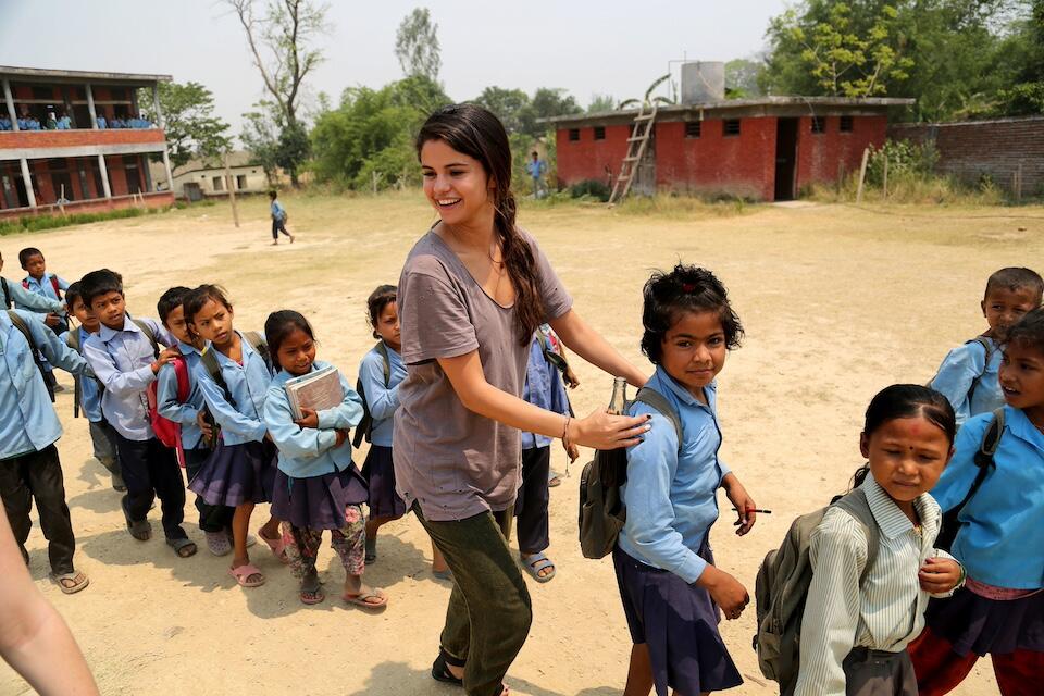 Selena Gomez, UNICEF Ambassador since 2009, joins school children for a game during a program visit.