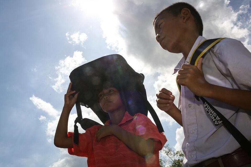 Children walk back to the classroom after taking an afternoon break in Thailand. 