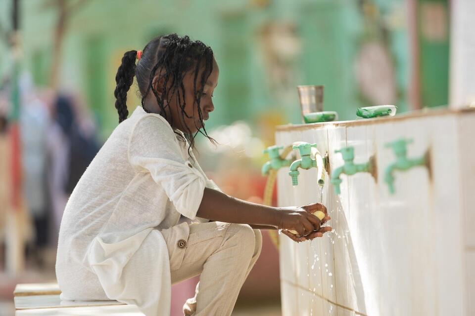 Naba washes her hands in a UNICEF safe learning space in Kassala, Sudan.