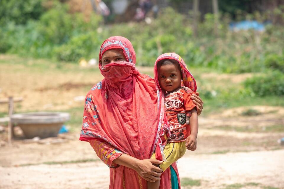 Ayesha Begum with her son Abu Raihan struggles to cope in the soaring heat in Amnura, Jhilim, Bangladesh on May 17, 2024 during a nationwide heat wave.