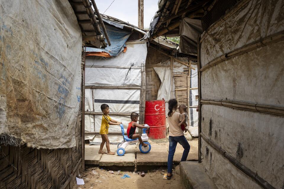 On July 14, 2024, children walk through the narrow streets between shelters in the Rohingya refugee camps in Cox’s Bazar, Bangladesh.