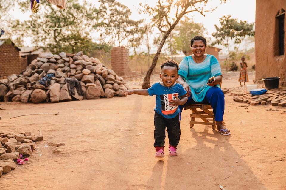 One-year-old Gabriel joyfully plays with his mother Sarah outside their home in Kamanyola, South Kivu province, Democratic Republic of the Congo, on July 24, 2024. Gabriel survived mpox at the UNICEF-supported Kamanyola Hospital.