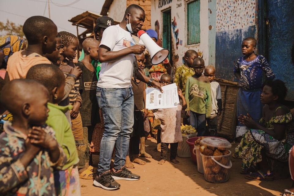 Innocent Murula, a UNICEF-supported community outreach worker, uses his megaphone to raise community awareness about mpox in Kamanyola, South Kivu province, DRC, on July 25, 2024.