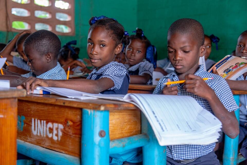 Students use materials from UNICEF school kits at the national school of Dame Marie in Grand Anse, Haiti. 