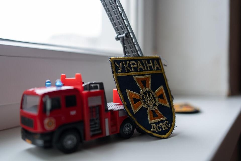 Nine-year-old Andrii's firefighter's toy car and SES badge, presented by the head of an SES rescue station in Kherson, Ukraine.