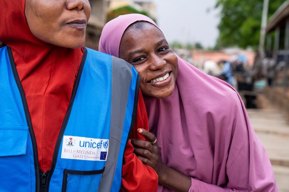 Hadiza Abdullahi Jariri, 25, right, accompanies her sister, local volunteer community mobilizer Shamsiyya Abdullahi Jariri, 30, to educate local families with girls aged 9-14 years about the week-long second phase of the single-dose human papillomavirus (HPV) vaccine rollout in Katsina, Nigeria. 