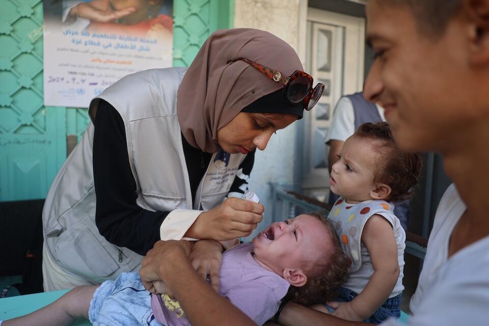 A health worker administers the polio vaccine to a young child at the Az Zawayda Clinic in the central Gaza Strip.