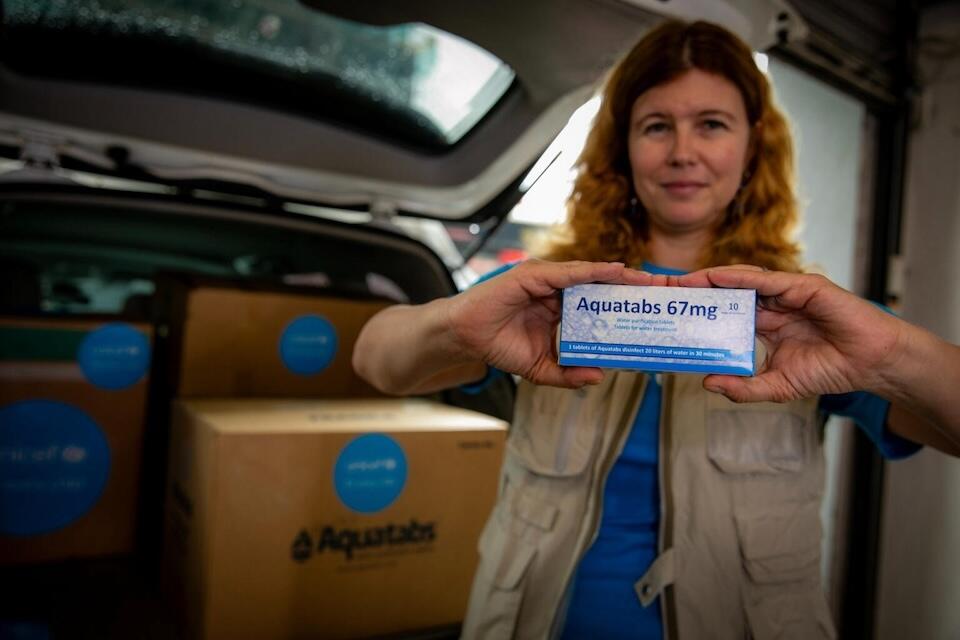 UNICEF Representative Silvia Danailov holds a box of water purification tablets, part of a shipment provided by UNICEF to government partners for distribution to communities affected by TyphoonYagi.