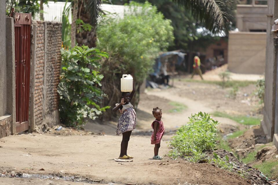 Two young children stand on a dirt path in Kamengue, Bujumbura, Burundi, where many mpox cases are being reported, and where UNICEF is helping strengthen the response to the outbreak.