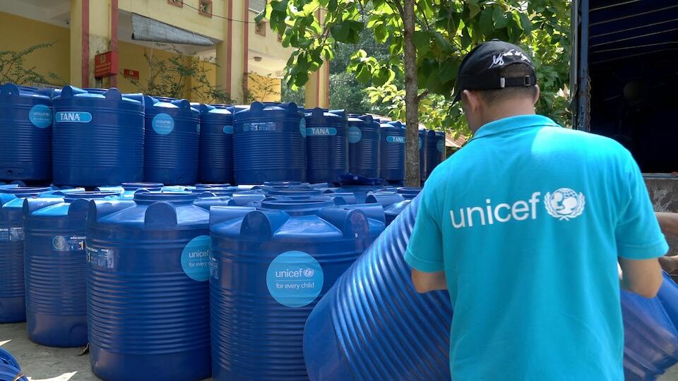 UNICEF Officer Trinh Duy Thuan delivers water tanks to families after Typhoon Yagi swept through Tan Linh commune, Yen Bai Province, Vietnam.