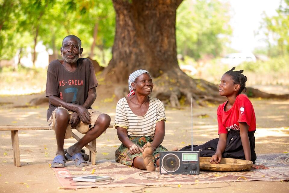 Chisomo Daimon, 18, right, with her grandparents, farmers in Nsanje District, Malawi.