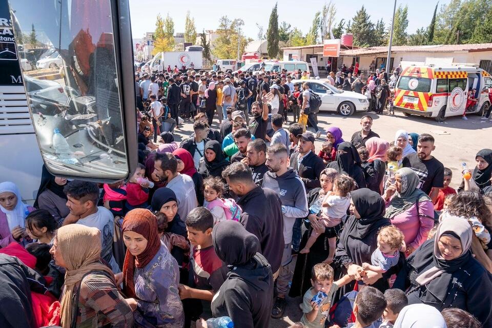 Syrian and Lebanese families fleeing escalating violence in Lebanon gather at the crossing border point to enter Syria, in Jdeidet Yabous, Rural Damascus, Syria, on Sept. 28, 2024.