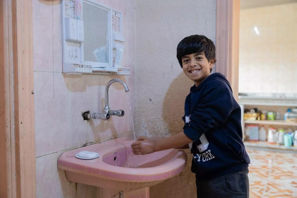 A boy in Mreighah district, Ma'an governorate, Jordan, enjoys access to safe water, thanks to a UNICEF-supported improvement project.