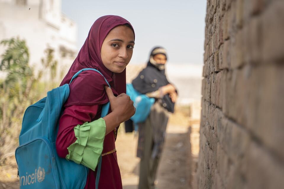 Muqadas glances back, anticipating another day of school tomorrow in Dera Ghazi Khan, Punjab, Pakistan.