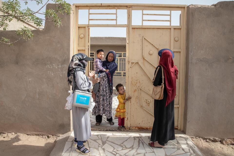 Volunteer vaccinators in Herat Province, Afghanistan, visit a home during a UNICEF-supported polio vaccination campaign. 