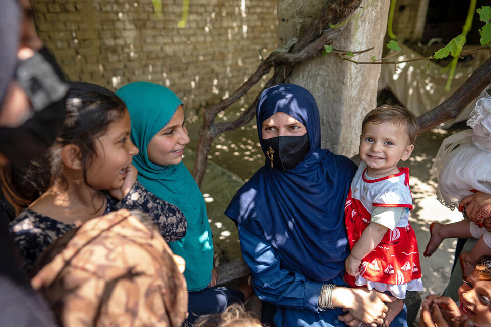 Madina, a community health worker, speaks to children at the UNICEF-supported Qalai Ishaq health post in Nangarhar province, eastern Afghanistan. Together with her father-in-law, Madina works out of her home to provide basic health care, advice and referrals to mothers and children under the age of five..