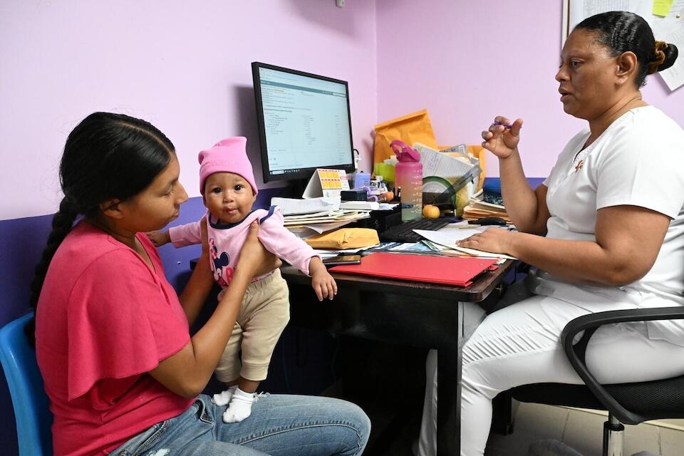 Four-month-old Ella with her mother at a routine checkup at Cleopatra White Health Clinic in Belize City, Belize.