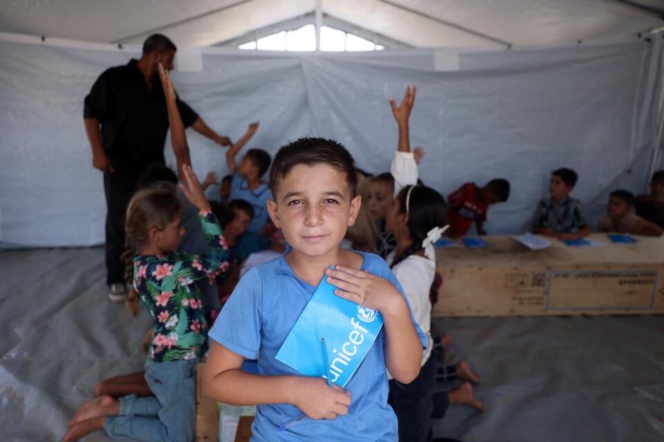 Ten-year-old Laith, displaced by conflict in Gaza, is able to continue his education in a temporary classroom set up, staffed and equipped by UNICEF with support from partners.