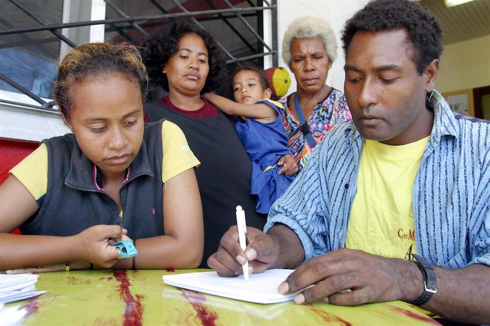 Badili, a young girl, giving birth registration details to a City Mission worker during a nationwide birth registration campaign.