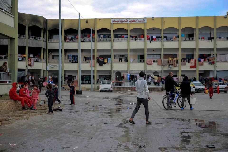 On Dec. 7, 2023, families displaced by air strikes take refuge in Kuwait School, northern Gaza Strip.