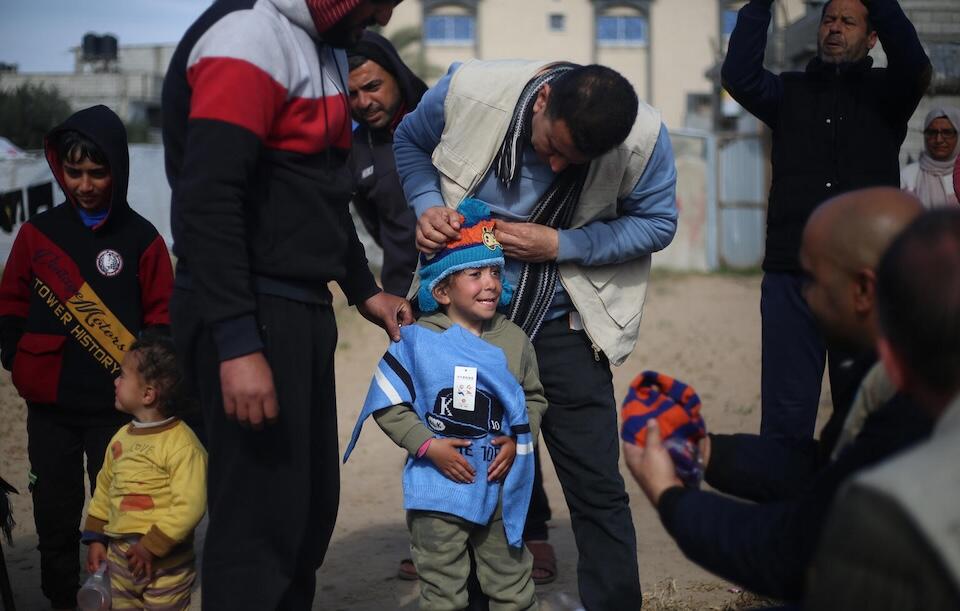 Palestinian children in Rafah try on their new winter clothes provided by UNICEF on Jan. 28, 2024.