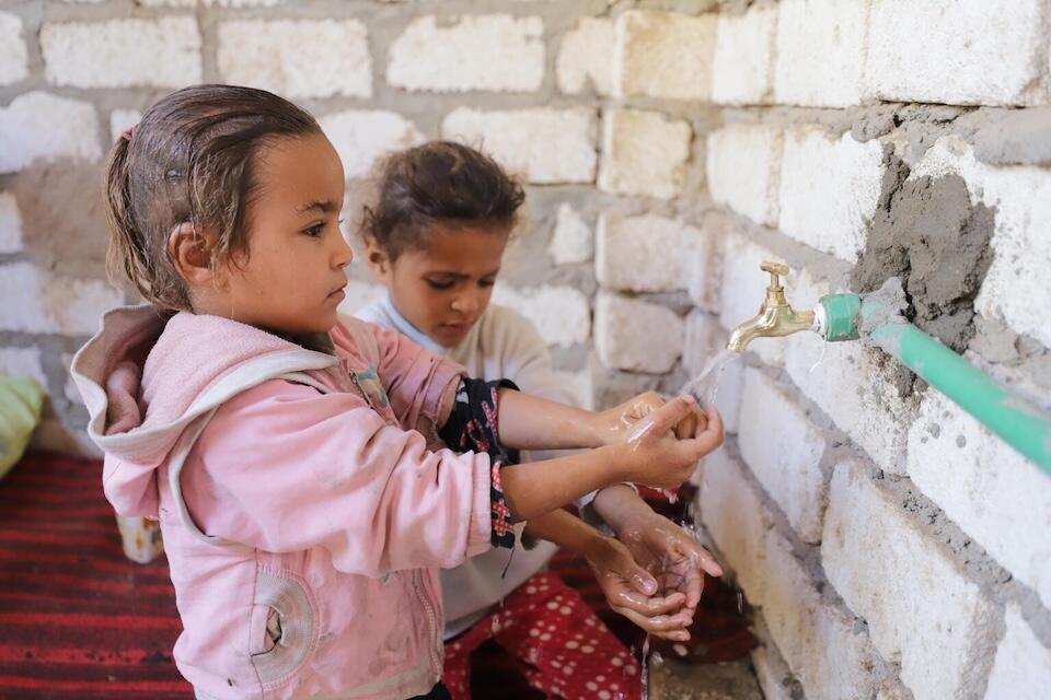 Children in the village of Kawala in Sohag Governorate, Egypt, an area that is extremely dry and hot in summer and very cold in winter, enjoy a water tap in their home for the first time. A UNICEF-supported revolving fund program provided this family and 88 others with a clean water connection at home in December 2023.