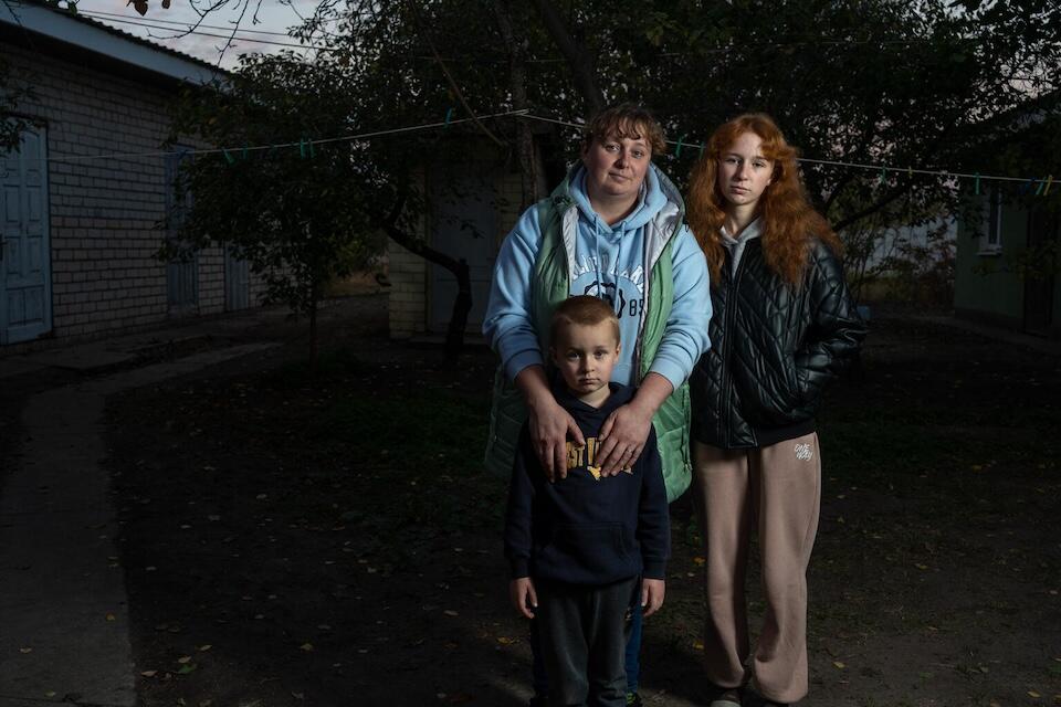 A family receiving winter heating support from UNICEF in  Khotimlya, Kharkiv region, Ukraine, in 2024.