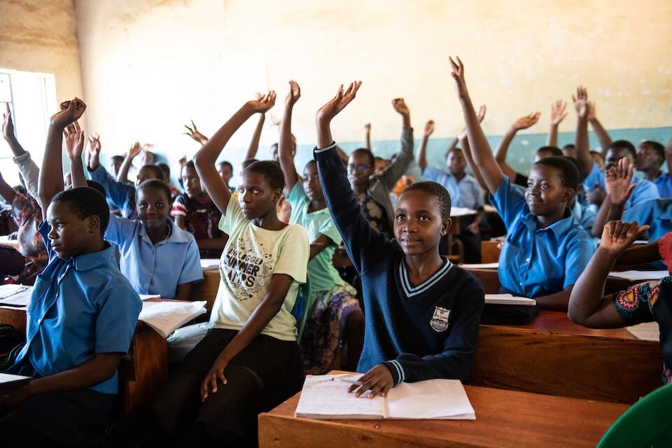 Students raise their hands in class at Bandawe Girls' Secondary School in Malawi.