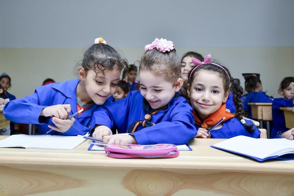 Aya, 6, Arwa, 6, and Loulya, 6, sit next to each other during a math class in a UNICEF-rehabilitated school in Hazzeh village, Rural Damascus, Syria, on Sept. 10, 2024.