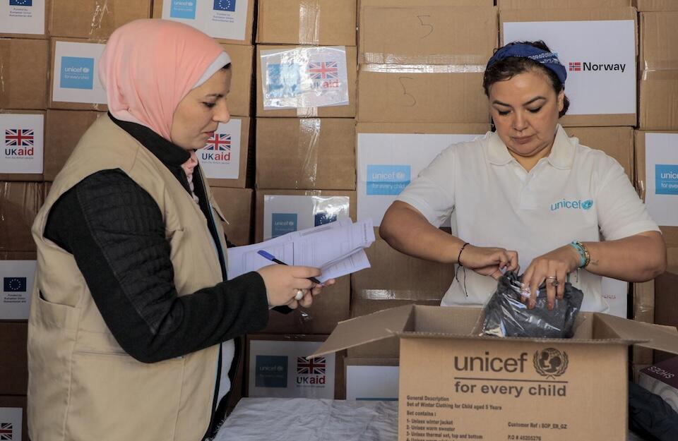 UNICEF and partners prepare boxes of warm winter clothes for children in Khan Younis, southern Gaza Strip.