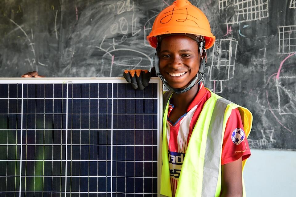 A 13-year-old student in Burkina Faso studying solar installation with UNICEF support.