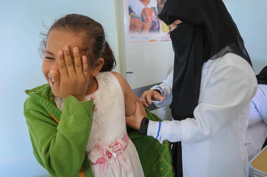 A child braces for a Measles and Rubella vaccination given by a local health worker through a UNICEF-backed campaign in Bani Alhareth, Sana’a, Yemen on 9 February 2019. 