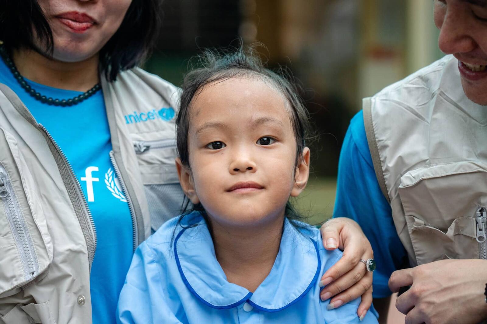 UNICEF staff talk to Hoang, 6 years old.