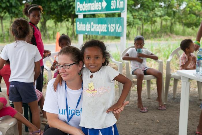 Belen Carillo, UNICEF Ecuador child protection specialst, with Kimberly,6, at the “Y” encampment just outside of San Jose de Chamanga, Ecuador. 