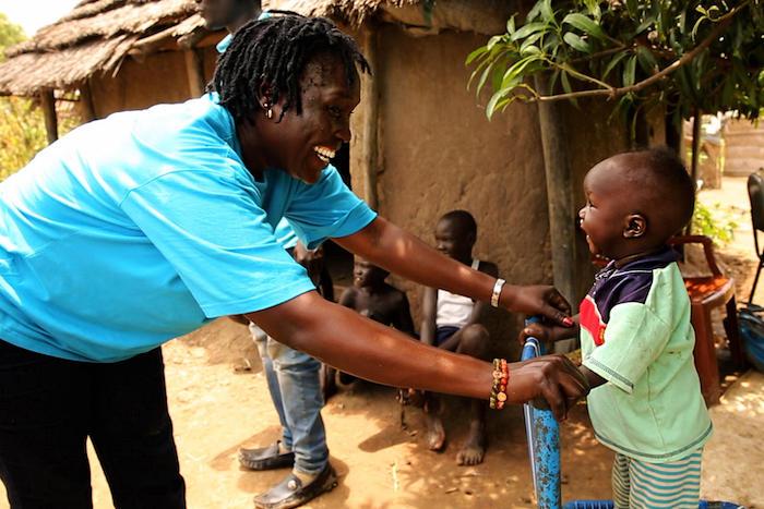 Ten-month-old Akot plays with UNICEF nutritionist Jesca Wude Murye outside Akot's home in Aweil, South Sudan in September 2019.