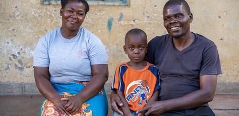 On Jan. 31, 2024, a family sit on the porch of their house in Lilongwe District, Malawi. 