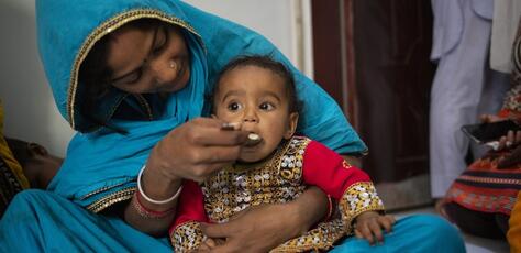 A mother feeds her 10-month-old daughter at a UNICEF nutrition counseling session on complementary feeding on Feb. 29, 2024, in Lyari, Karachi, Sindh, Pakistan. 