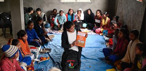 A peer facilitator displays materials from the Rupantaran tool kit provided by UNICEF to a class of adolescent girls in Nepal’s Maharajganj Municipality. 