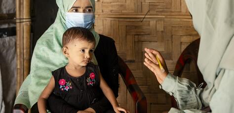 On July 15, 2024, UNICEF-trained Rohingya community nutrition volunteer Taslima visits Noor Bibi, 28, to provide nutrition counseling and to assess the nutritional status of her daughter Jishan, 2, at their shelter in the Rohingya refugee camps in Cox’s Bazar, Bangladesh.