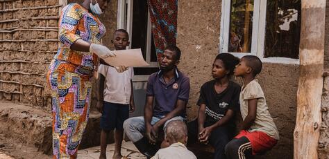 Mwamini Badesire, a community leader and UNICEF-supported community outreach worker, raises awareness about mpox symptoms and prevention measures with the Amani family in Chireja village, South Kivu province, DR Congo, on Sept. 13, 2024.