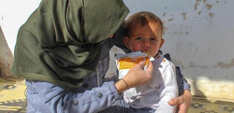 In Obada village, Rural Damascus, Syria on Dec. 17, 2024, a mother feeds her 1-year-old son a preventive food supplement distributed by UNICEF.